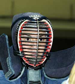 girl wearing a protective face mask for kendō.