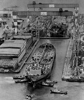 Tugboats pushing a ship into port
