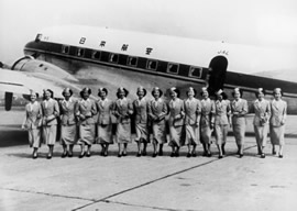 Flight attendents in front of prop plane