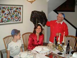 Jewish family sitting at dinner table.