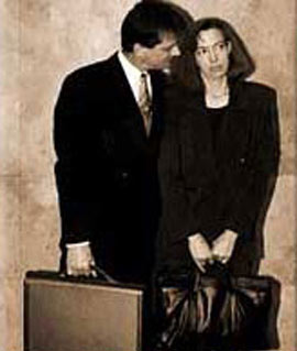A man standing very close to a woman